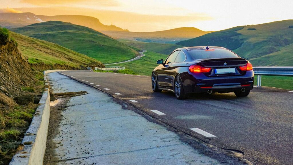 An automobile going down a countryside road