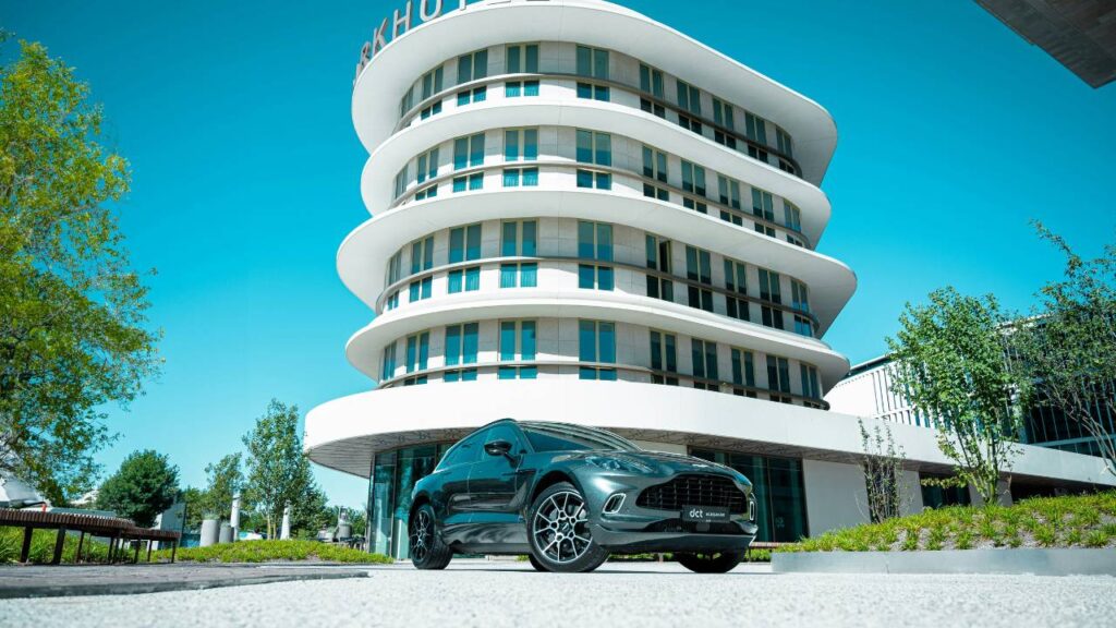 A modern automobile parked in front of a hotel