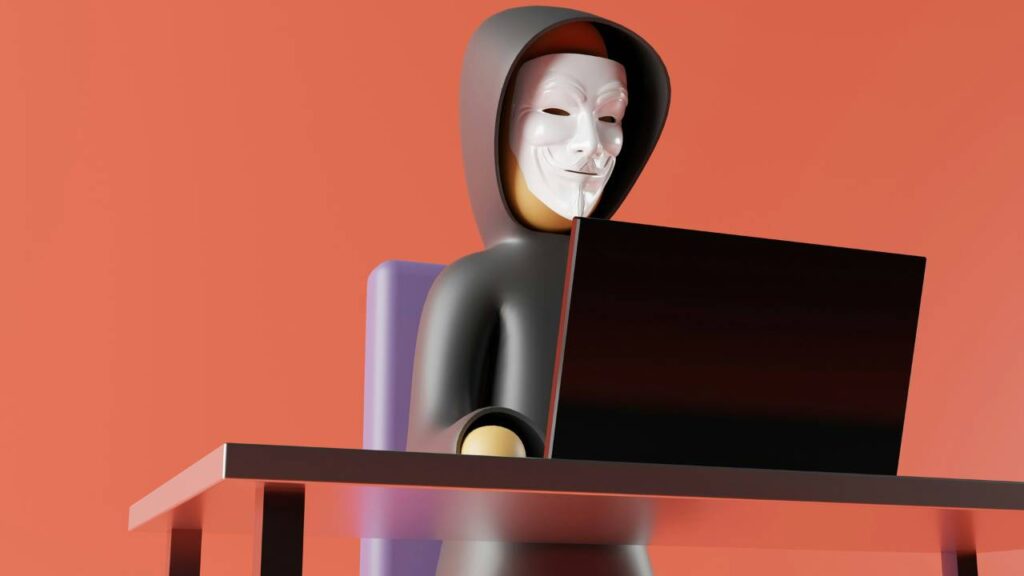 A figurine of a hacker using a laptop