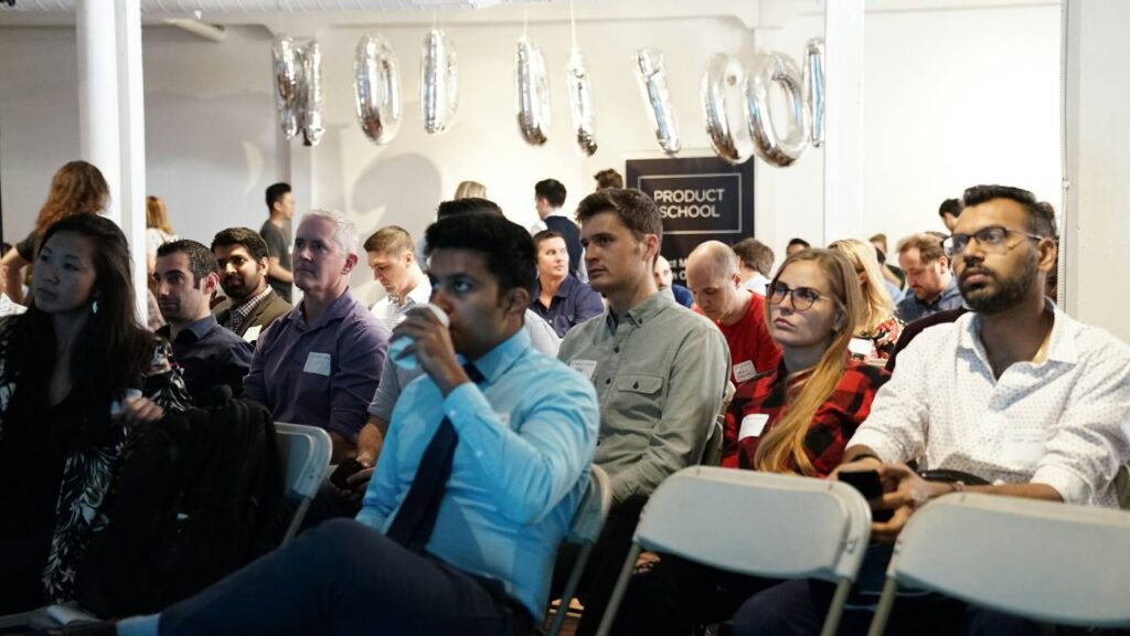 People sitting and listening at a leadership course training session