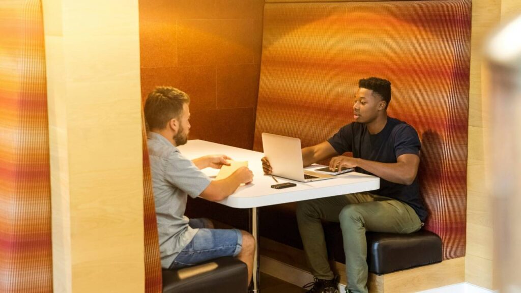 Two office workers talking to each other