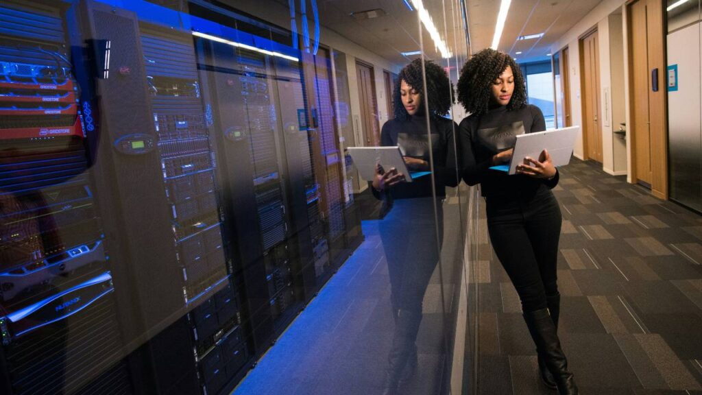 A woman using a laptop in the server room