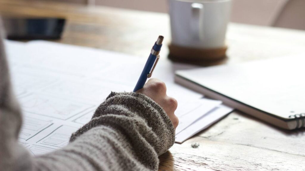 Woman using a pen to write on paper